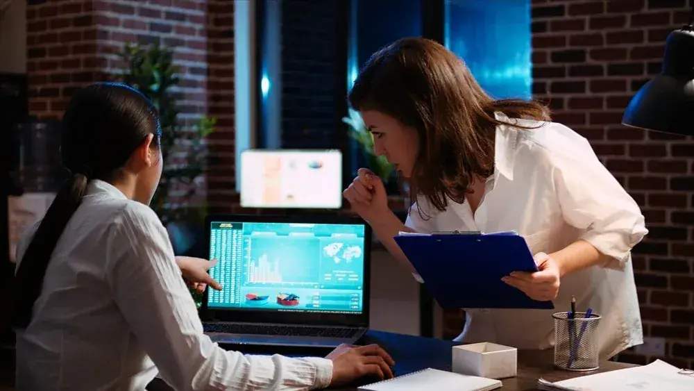 Professional IT consultant working on a laptop with digital interface overlay