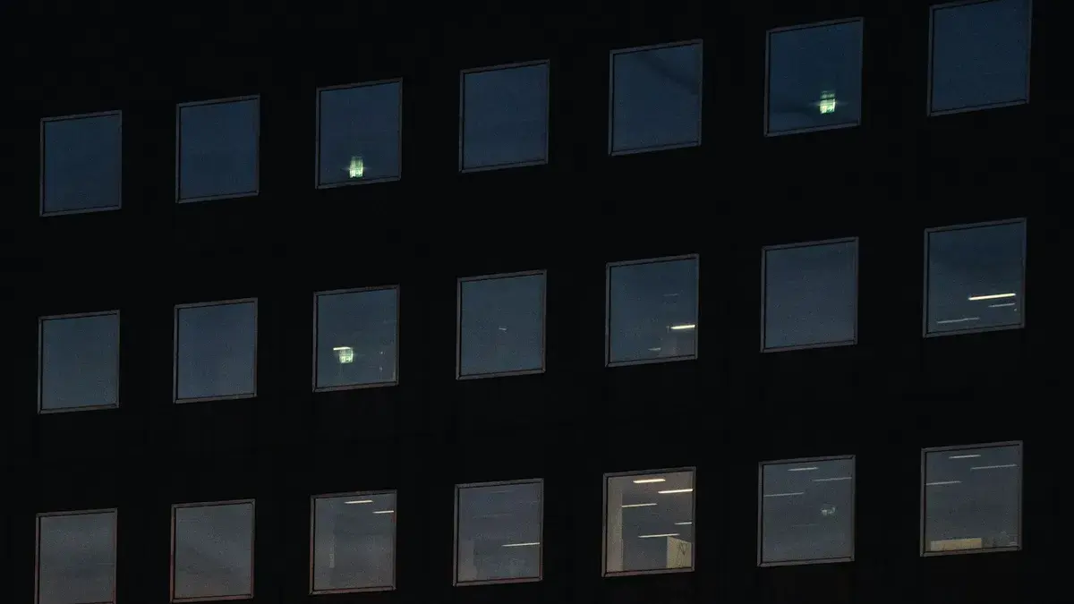 Office building facade at dusk with a few floors still lit