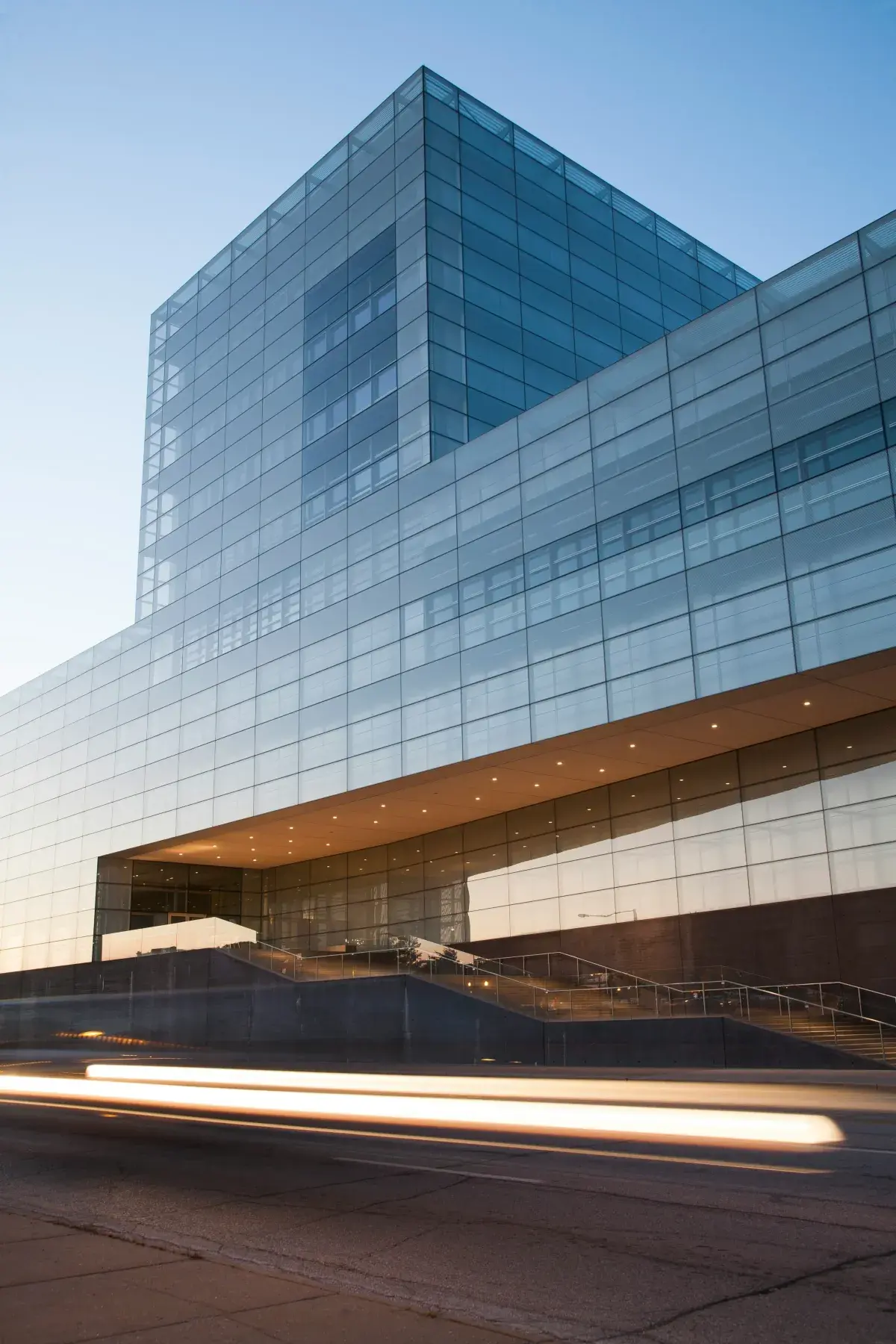 Modern glass corporate office building at dusk, representing enterprise-grade managed IT services