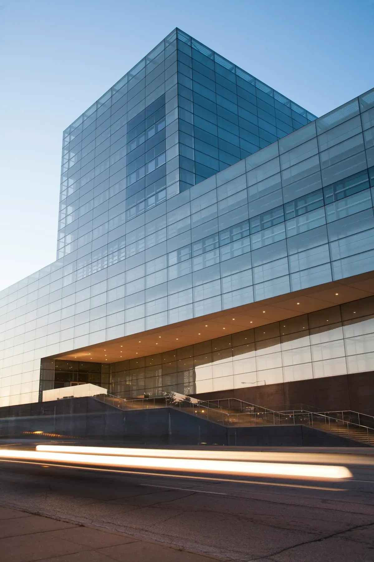 Modern glass corporate office building at dusk, representing enterprise-grade managed IT services