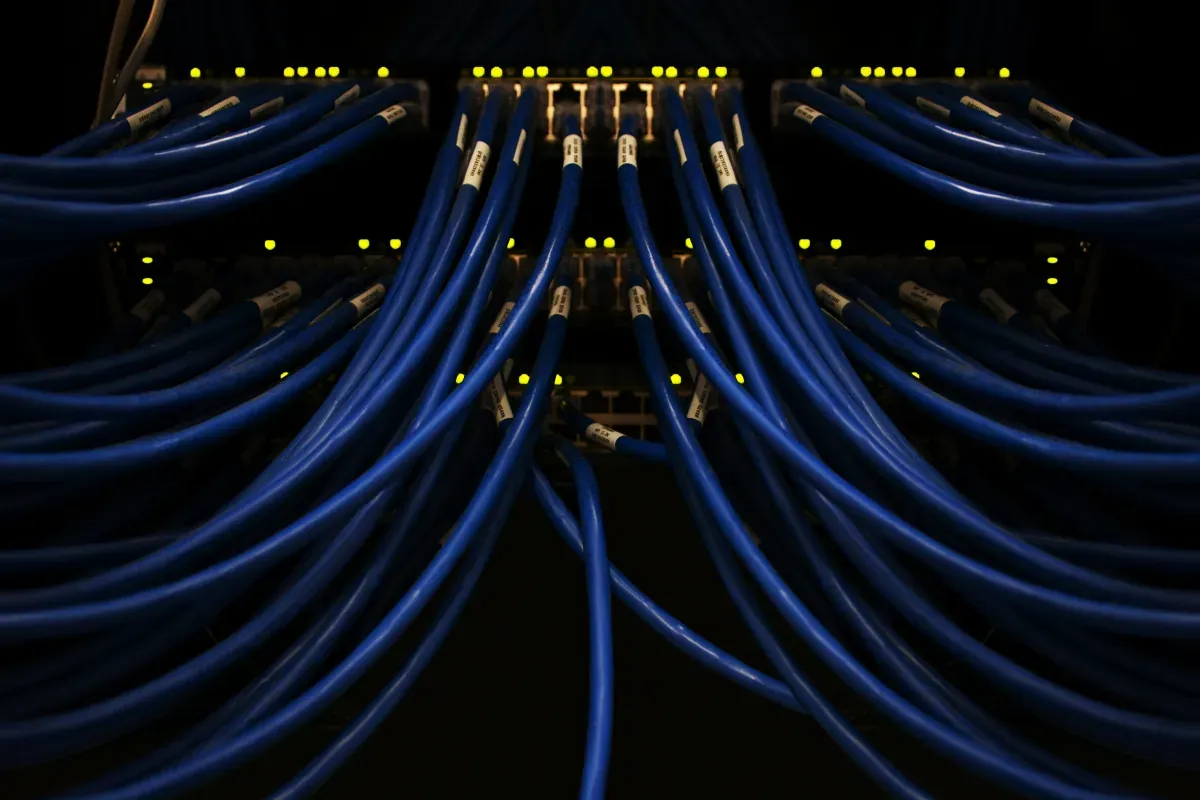Network cables in a server switch, representing 24/7 manufacturing IT operations
