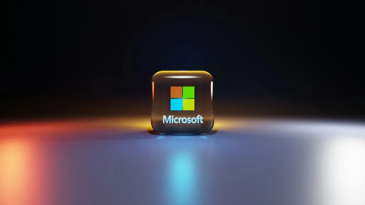 A glass cube with the Microsoft logo glowing against a dark background